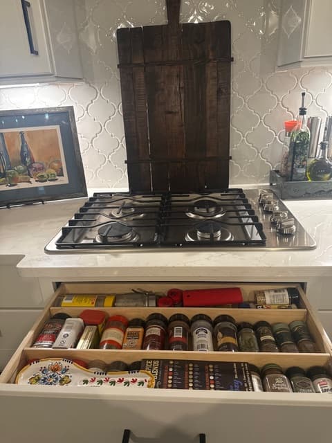 Custom pull-out shelving installed under cooktop