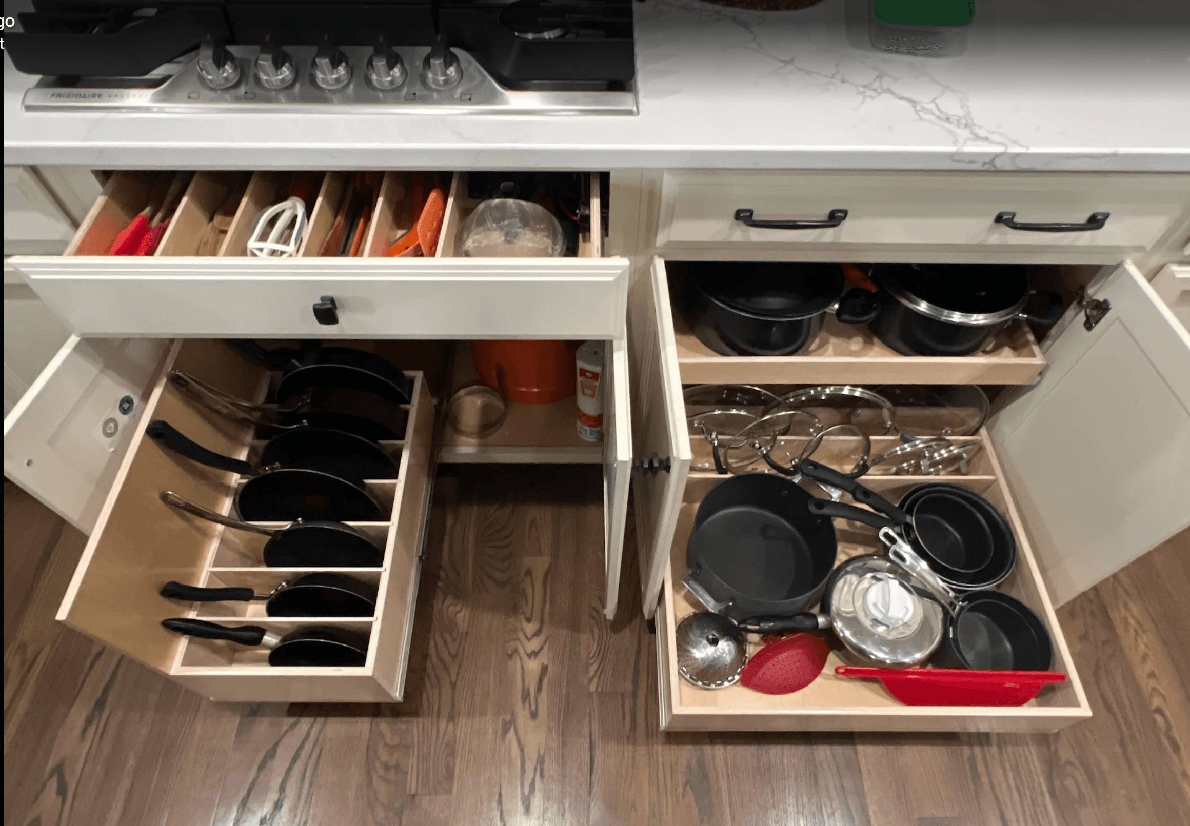 Under-cooktop pull-out shelf with pots and pans
