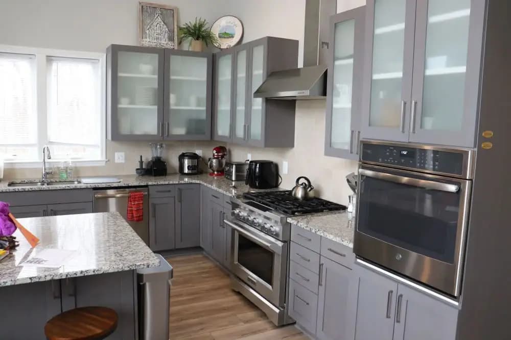 Kitchen cabinet before custom pull-out shelves — cluttered and disorganized